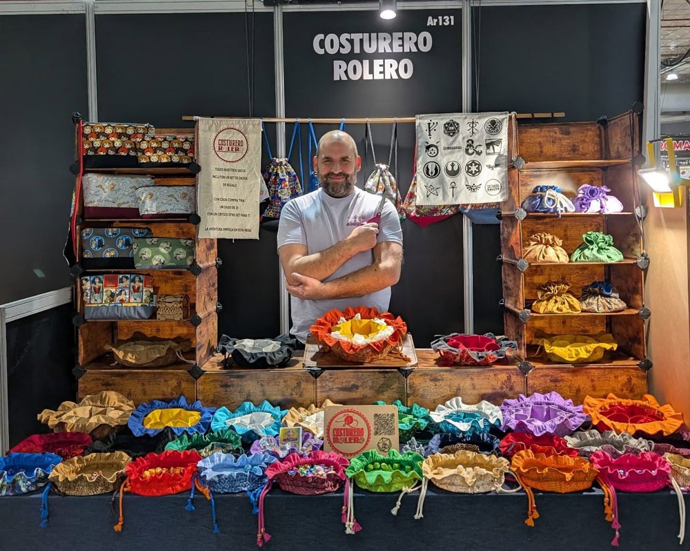 puesto de Costurero Rolero con saquitos de dados artesanales en feria de juegos de rol