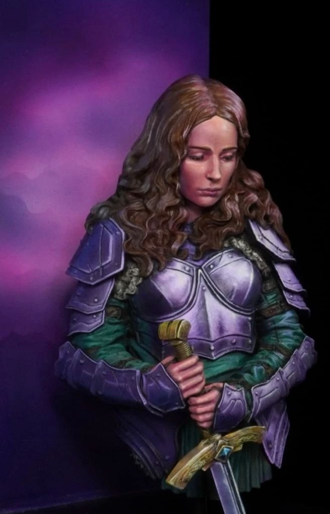 Busto femenino con armadura y espada en posición frontal, miniatura pintada a mano con fondo violeta
